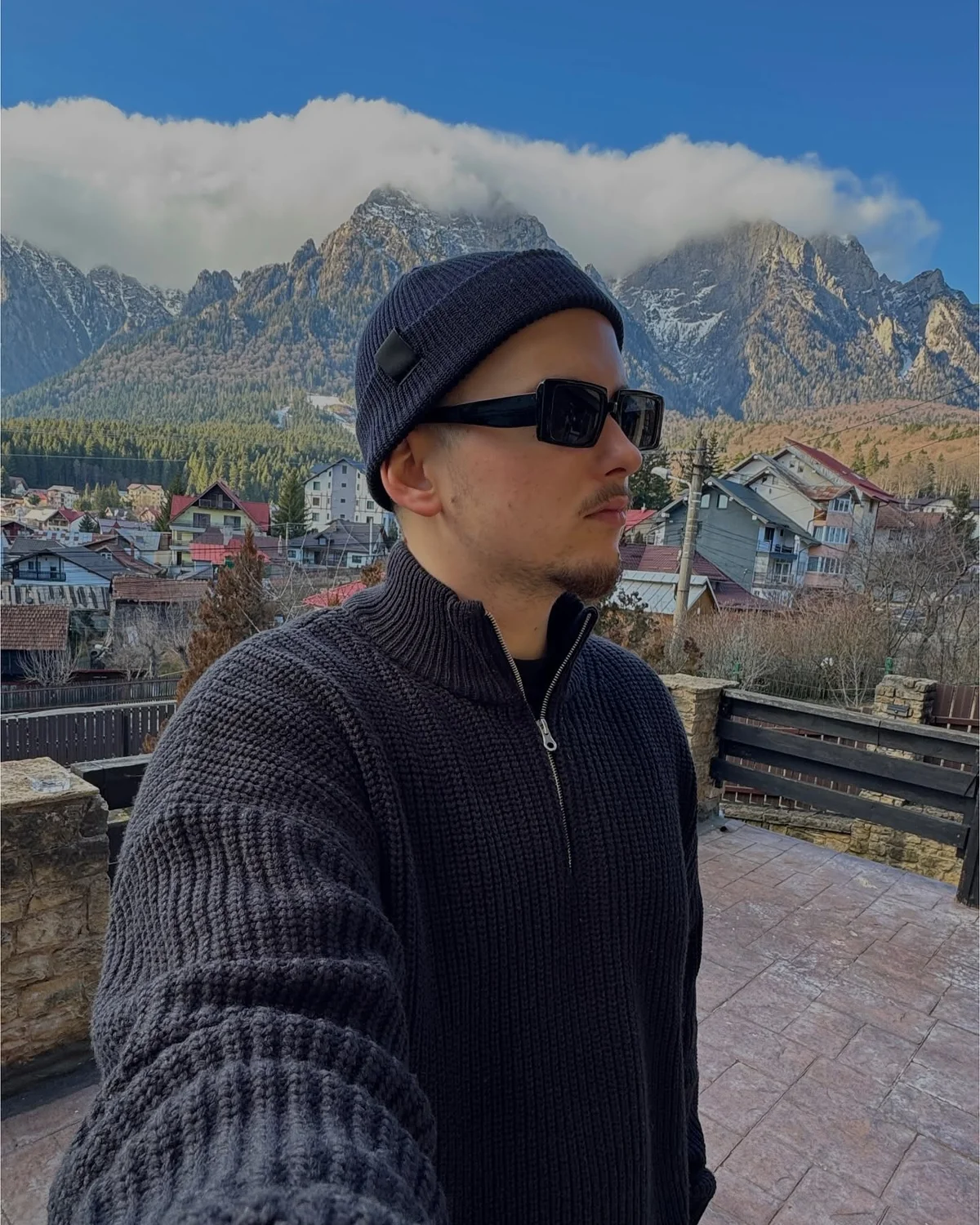 TonlART studio portrait against a mountain backdrop